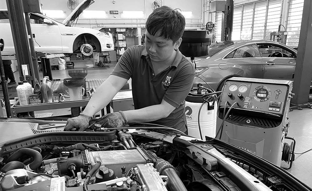 A Man Fixing The Engine Systems Of A Car